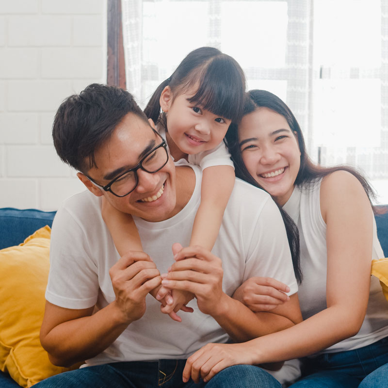 family smiling on couch